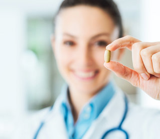 pharmacist holding a pill